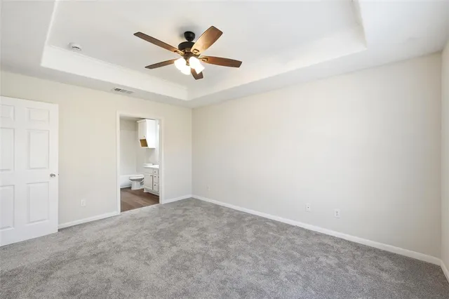 a view of a livingroom with a ceiling fan and wooden floor