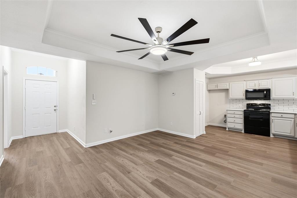 10124 Colony Drive Waco, TX 76708 - Photo 4 of 23 a view of a kitchen with wooden floor and a ceiling fan