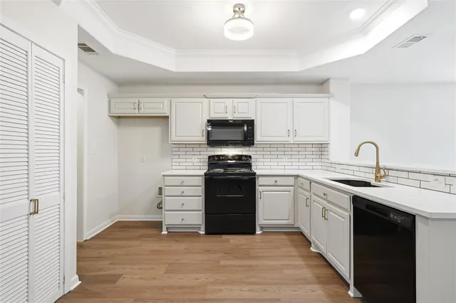 a kitchen with a sink stove and cabinets