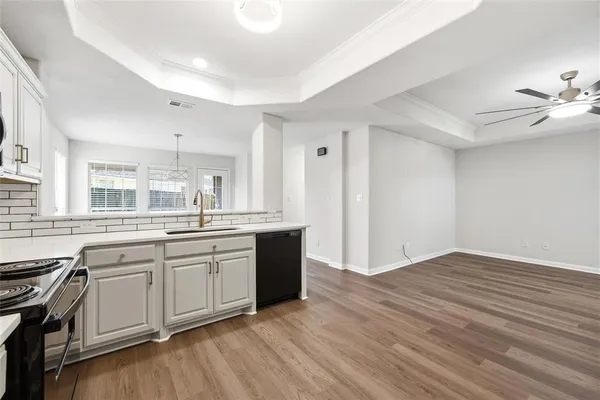 a large kitchen with granite countertop a stove top oven sink and cabinets