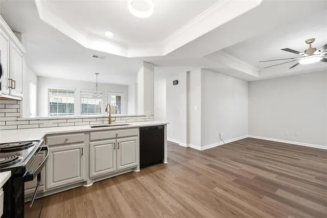 a large kitchen with granite countertop a stove top oven sink and cabinets