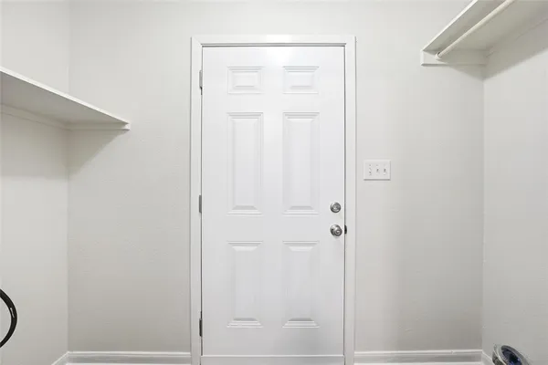a bathroom with a granite countertop shower and a door