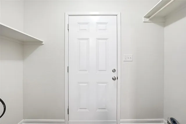 a bathroom with a granite countertop shower and a door