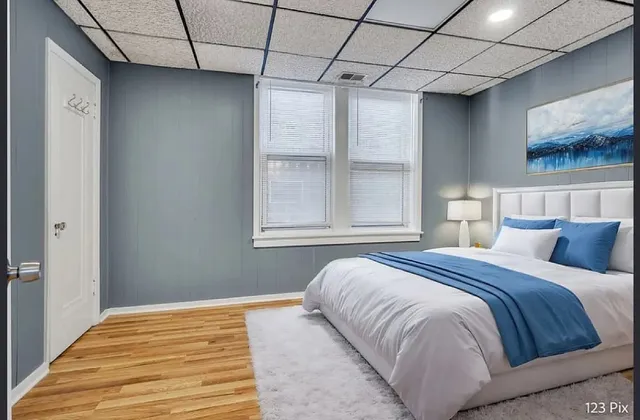 a bedroom with a bed and a window