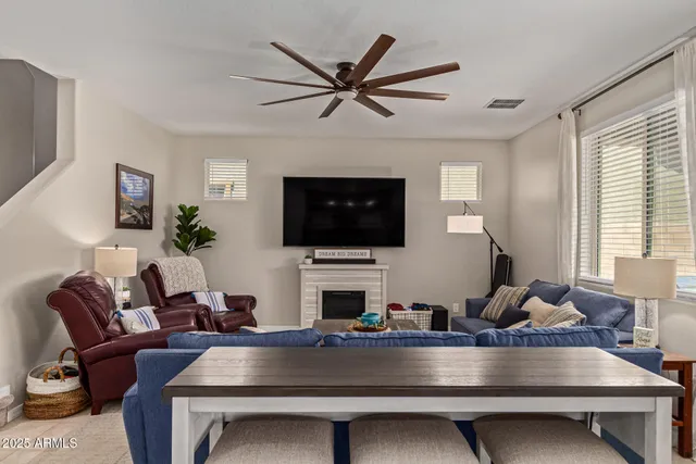 a living room with furniture flat screen tv and a fireplace