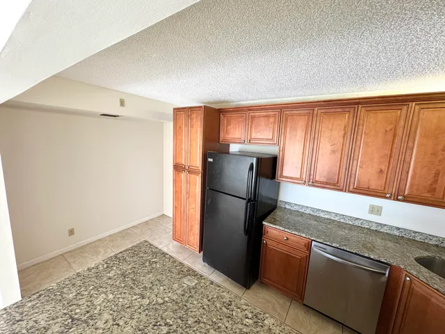 a kitchen with a refrigerator and a sink