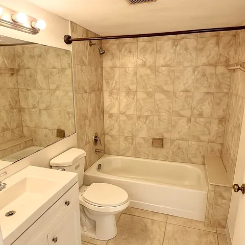 a bathroom with a toilet a sink and bathtub