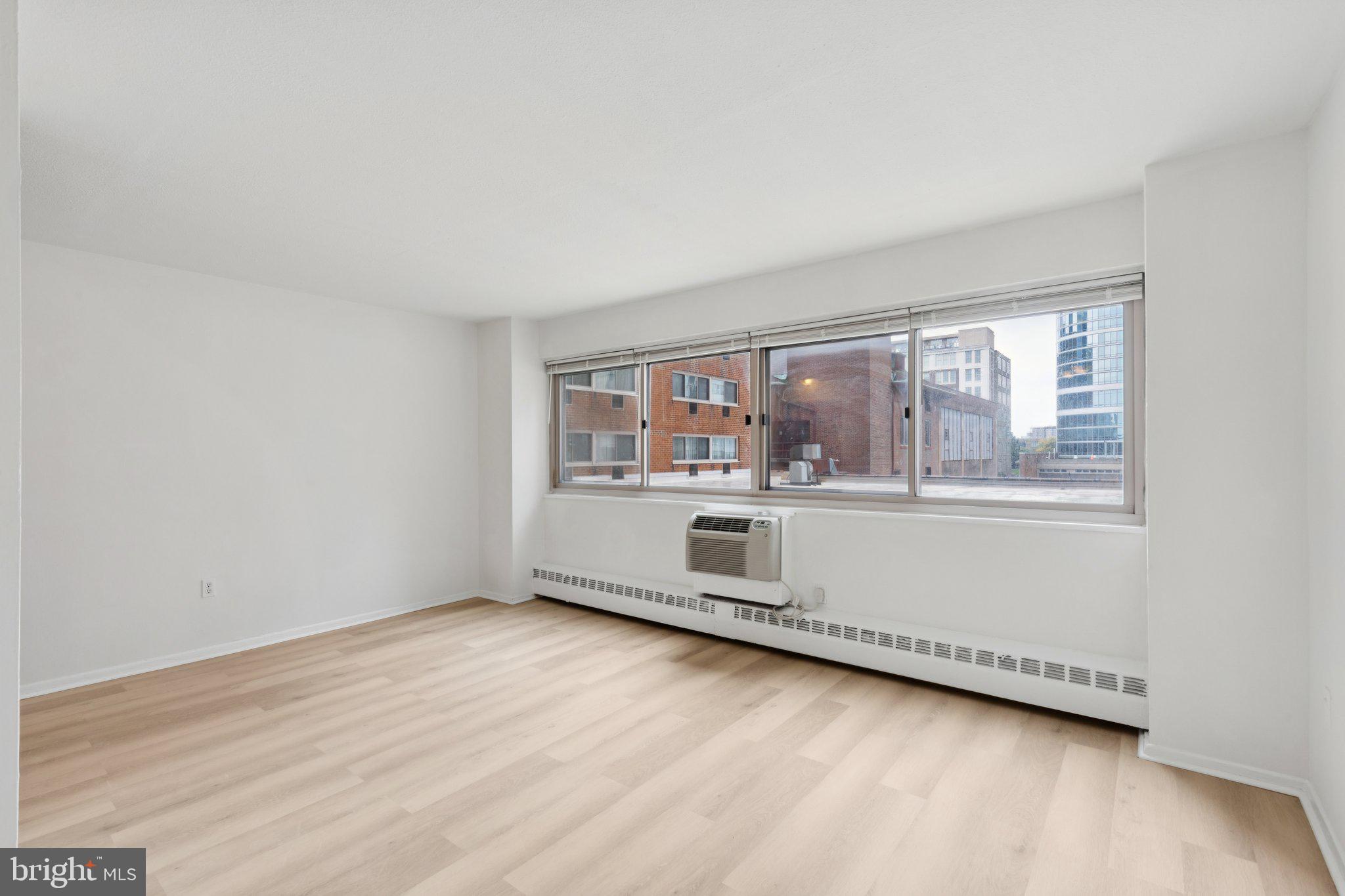 2101 Chestnut Street, Unit 324R Philadelphia, PA 19103 - Photo 1 of 21 an empty room with wooden floor and windows