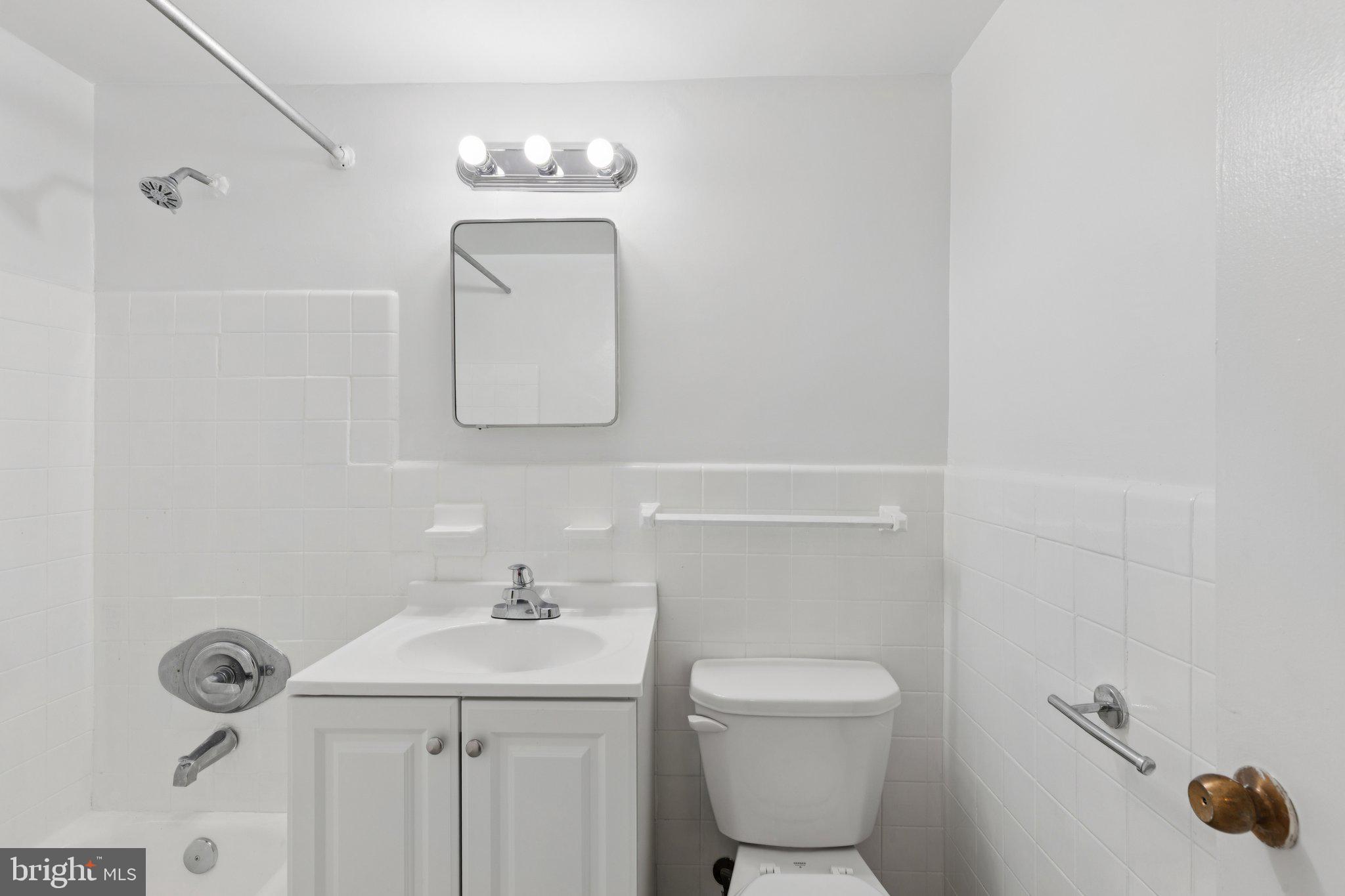 2101 Chestnut Street, Unit 324R Philadelphia, PA 19103 - Photo 12 of 21 a bathroom with a toilet a sink and mirror