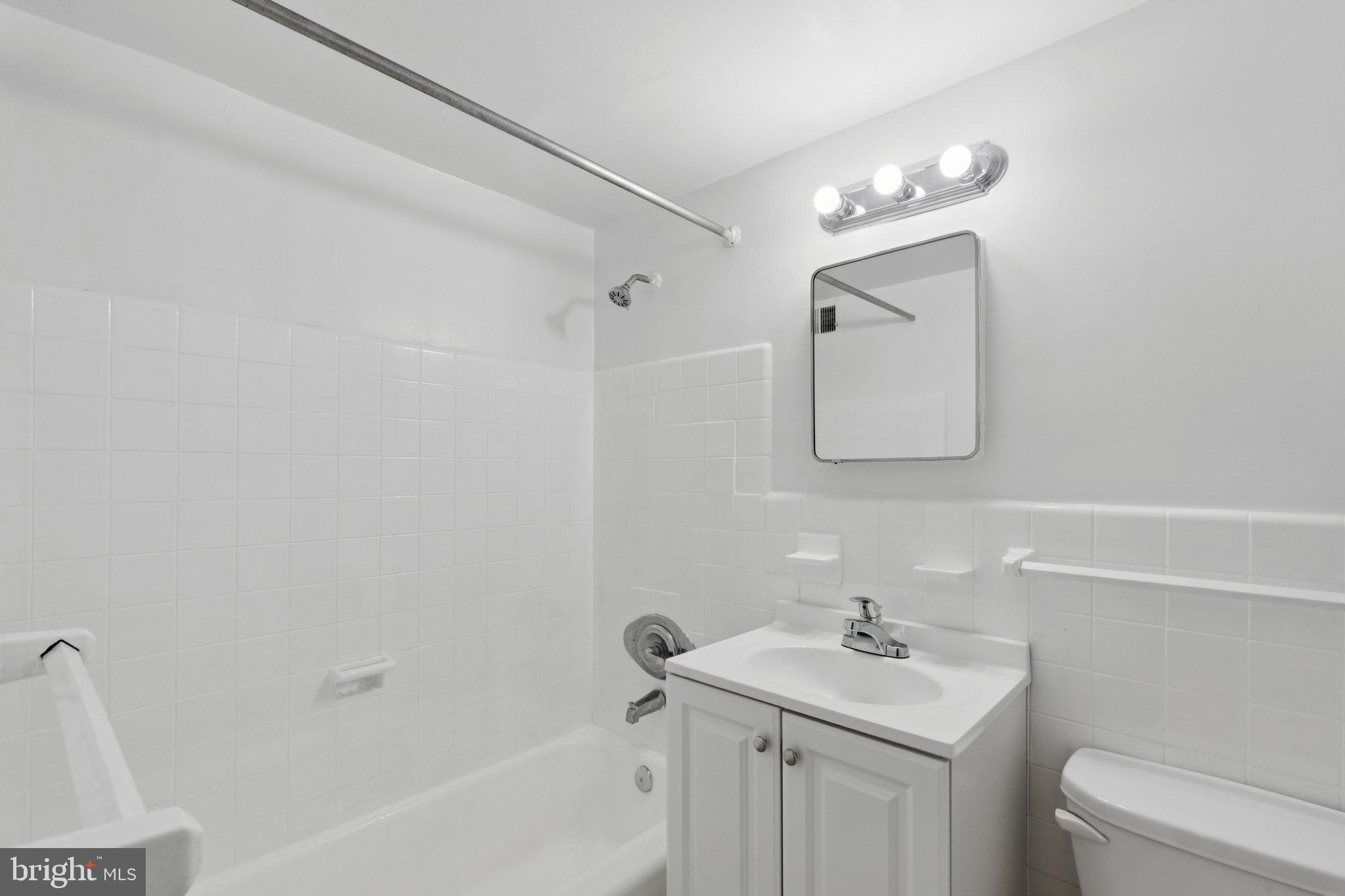 2101 Chestnut Street, Unit 324R Philadelphia, PA 19103 - Photo 13 of 21 a bathroom with a sink toilet and mirror