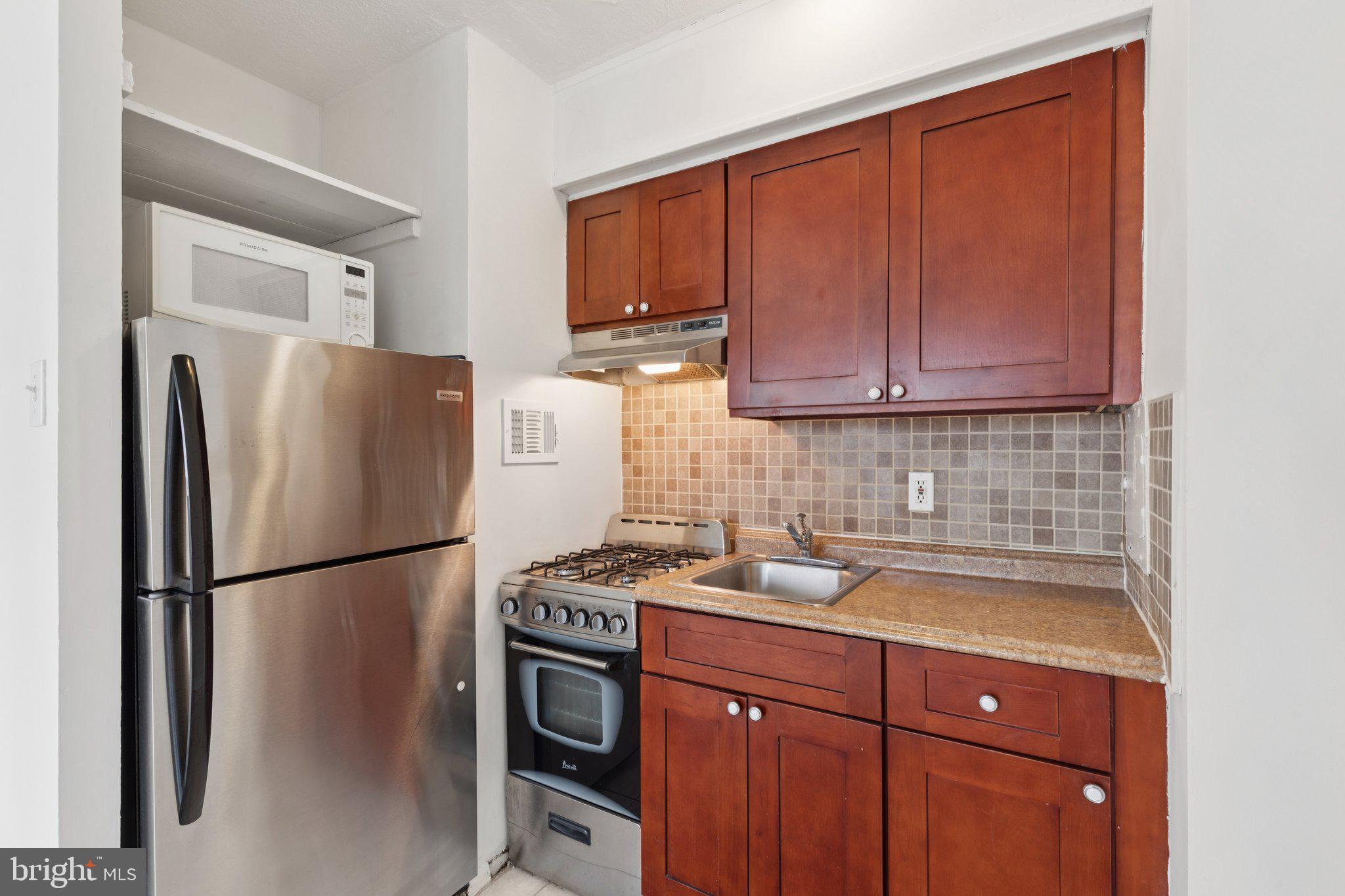 2101 Chestnut Street, Unit 324R Philadelphia, PA 19103 - Photo 8 of 21 a kitchen with a refrigerator sink and cabinets
