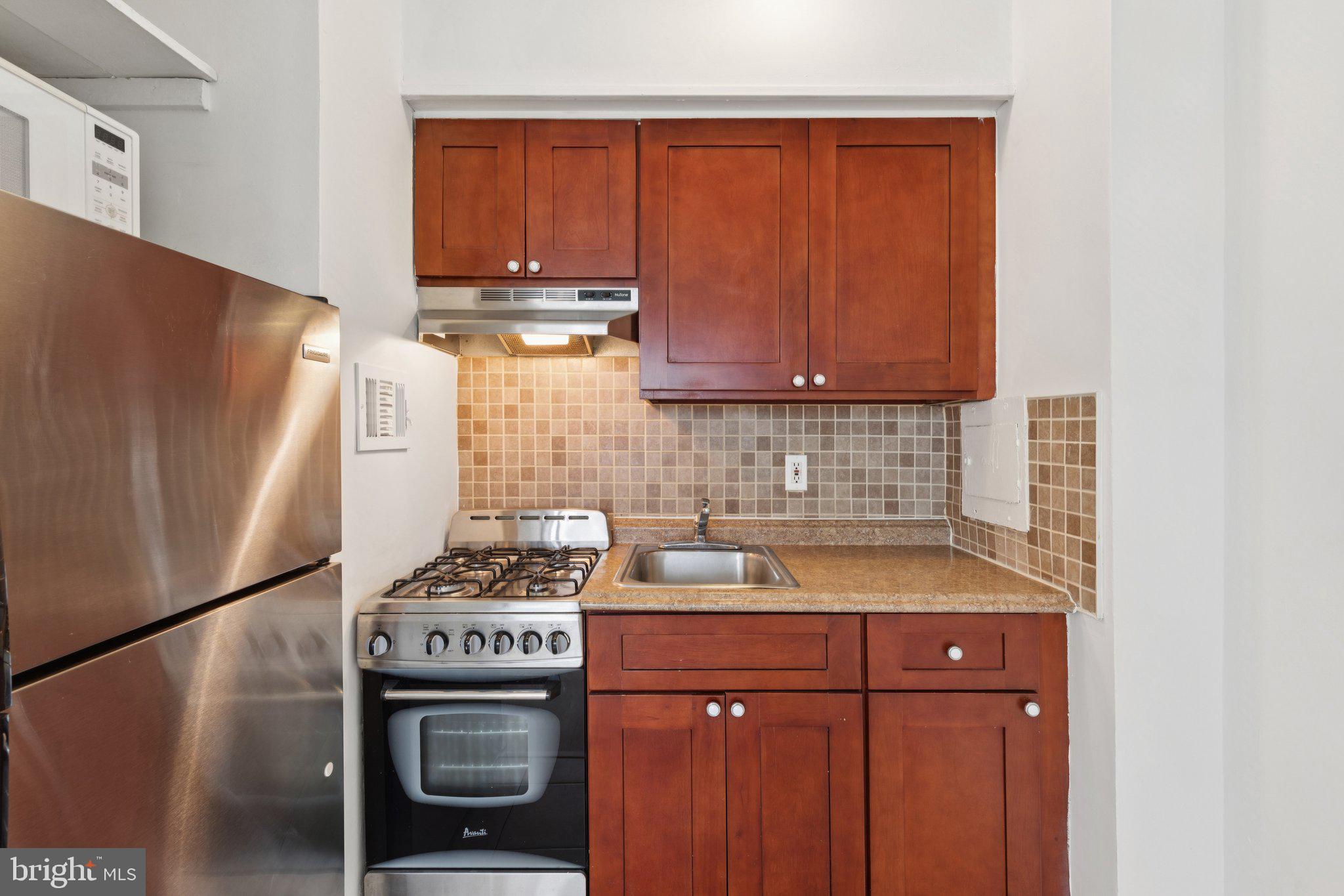 2101 Chestnut Street, Unit 324R Philadelphia, PA 19103 - Photo 9 of 21 a kitchen with a stove and a refrigerator