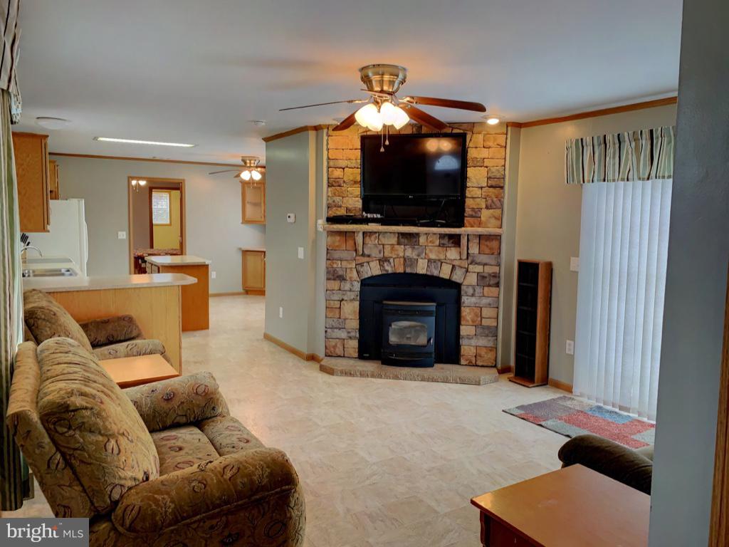 1340 Evering Avenue Rosedale, MD 21237 - Photo 3 of 34 a living room with furniture a flat screen tv and a fireplace