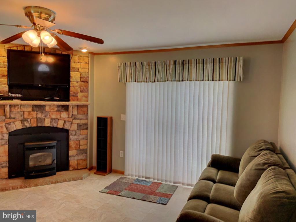 1340 Evering Avenue Rosedale, MD 21237 - Photo 4 of 34 a living room with furniture a flat screen tv and a fireplace