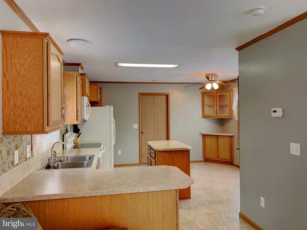 1340 Evering Avenue Rosedale, MD 21237 - Photo 8 of 34 a kitchen with sink a refrigerator and cabinets