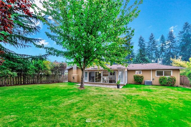 a view of a house with a yard and sitting area