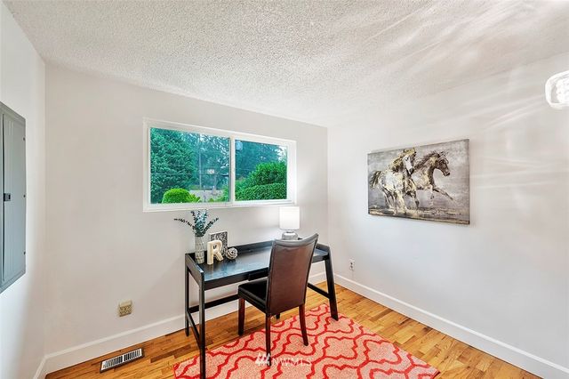 a workspace room with furniture and a window