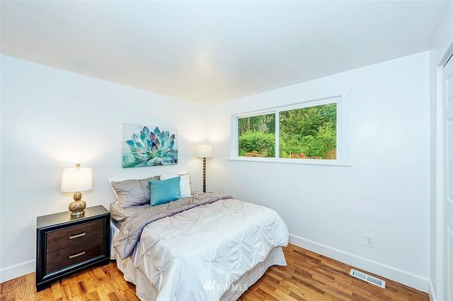 a bedroom with a bed dresser and a window