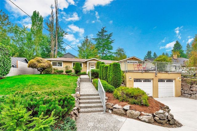 a front view of a house with a yard table and chairs