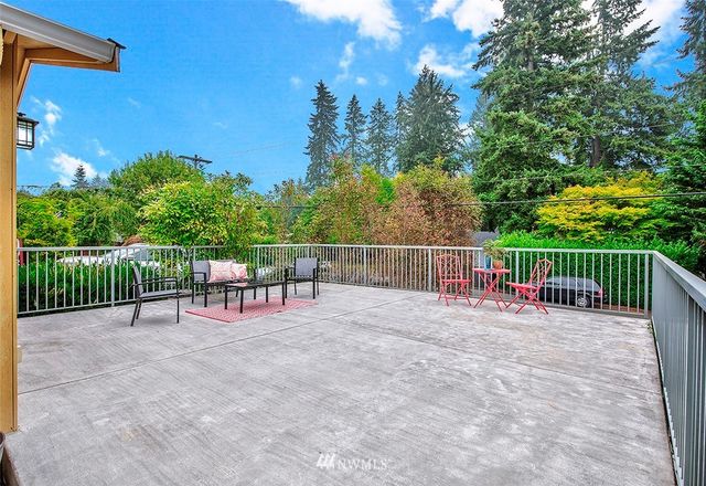 a view of a chairs and table on the wooden fence