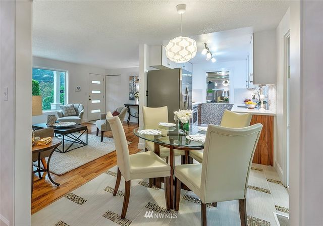 a dining room filled with furniture and wooden floor