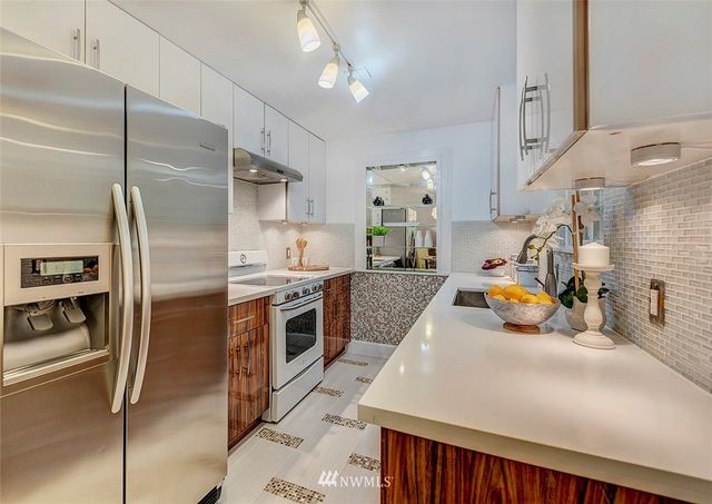 a kitchen with a refrigerator and a sink