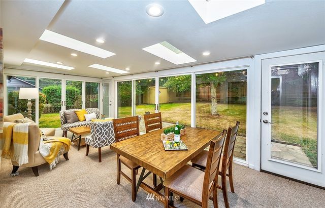 a view of a dining room with furniture window and outside view
