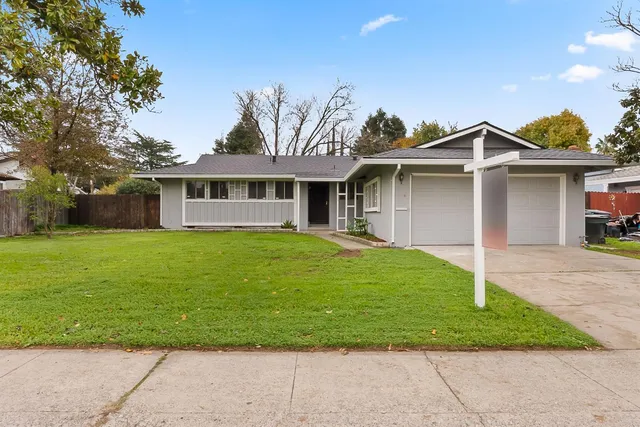 a front view of a house with a garden