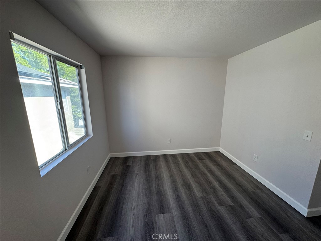 39790-39790 Monarch Drive Murrieta, CA 92563 - Photo 13 of 22 an empty room with wooden floor and windows