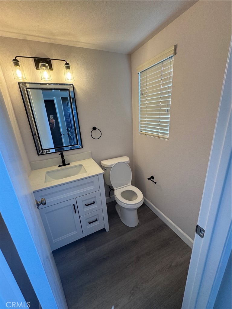 39790-39790 Monarch Drive Murrieta, CA 92563 - Photo 14 of 22 a bathroom with a toilet sink and mirror