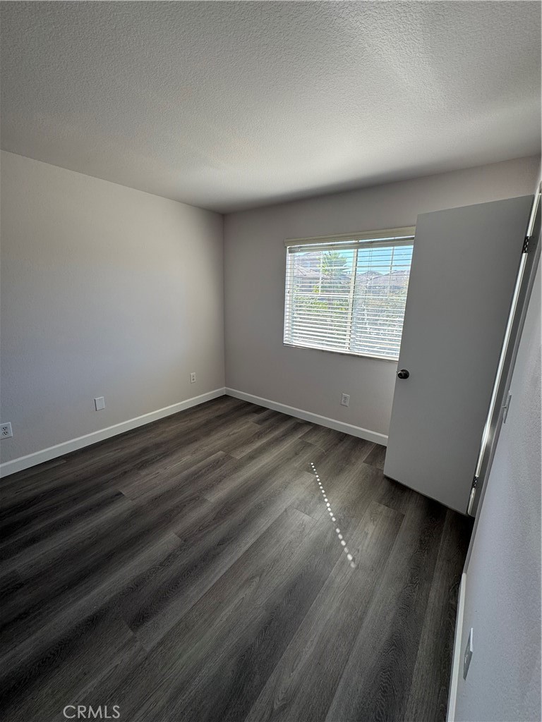 39790-39790 Monarch Drive Murrieta, CA 92563 - Photo 16 of 22 an empty room with wooden floor and windows