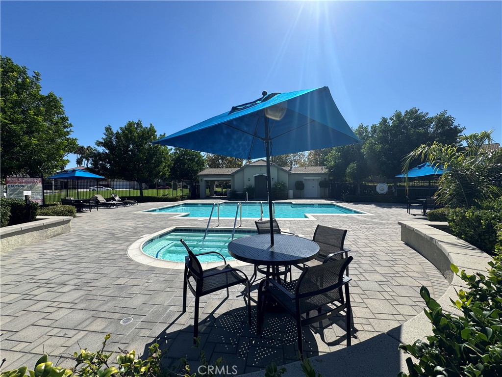 39790-39790 Monarch Drive Murrieta, CA 92563 - Photo 18 of 22 a patio with a table and chairs under an umbrella