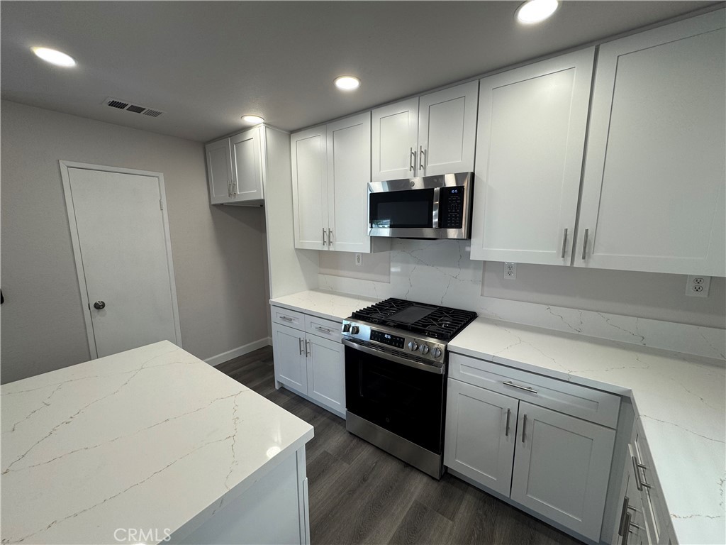 39790-39790 Monarch Drive Murrieta, CA 92563 - Photo 5 of 22 a kitchen with stainless steel appliances a stove a sink a refrigerator and a microwave
