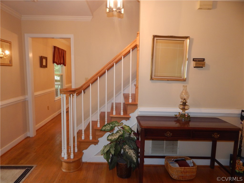 10321 Robbie Road Chesterfield, VA 23832 - Photo 5 of 20 a living room with wooden floor potted plants and a fireplace