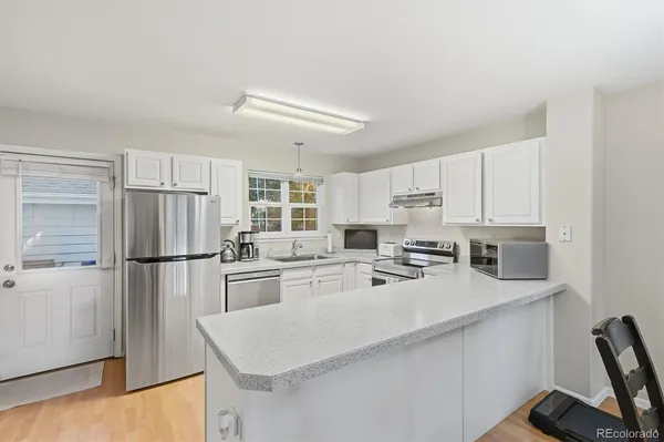 a kitchen with refrigerator a stove a sink and a refrigerator