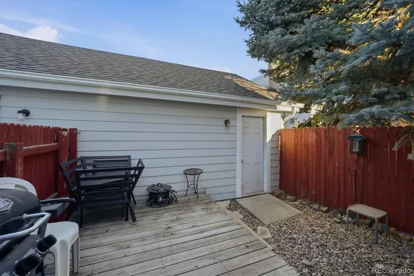 a backyard of a house with barbeque oven and outdoor seating