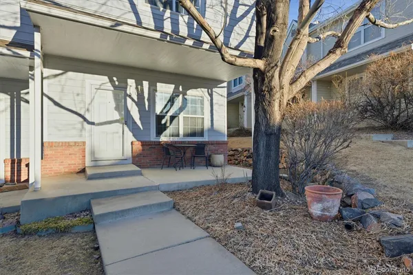 a view of a porch with furniture and a yard