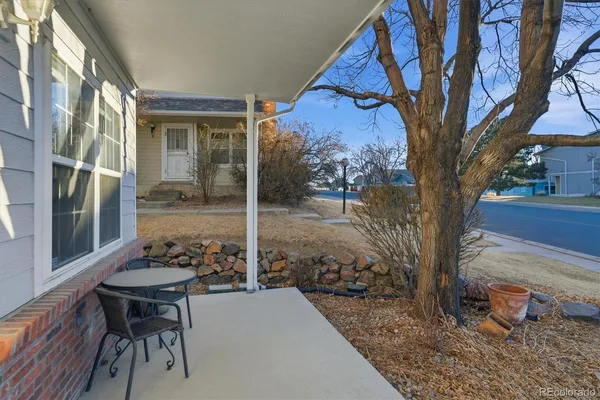 a backyard of a house with table and chairs