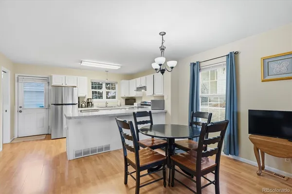 a view of a dining room with furniture window and wooden floor