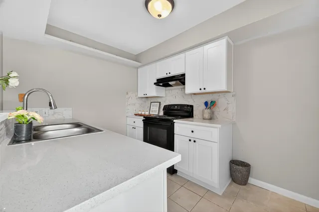 a kitchen with a sink stove and microwave