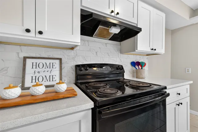a kitchen with a sink and a stove top oven