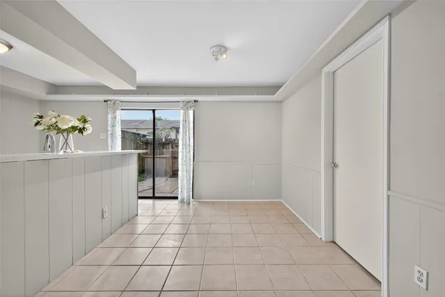 a kitchen with white cabinets and appliances