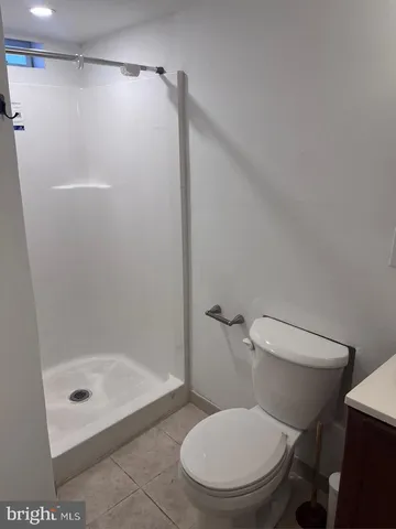 a white toilet sitting next to a bath tub