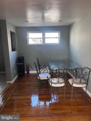 a living room with hard wood flooring and furniture