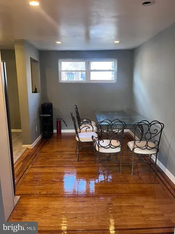 a room with furniture pool table and window
