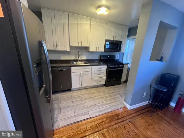 a kitchen with granite countertop stainless steel appliances and wooden cabinets