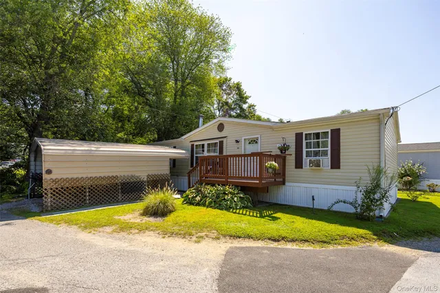 a view of a house with a patio and a yard