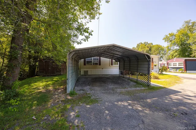 a view of a house with backyard and trees