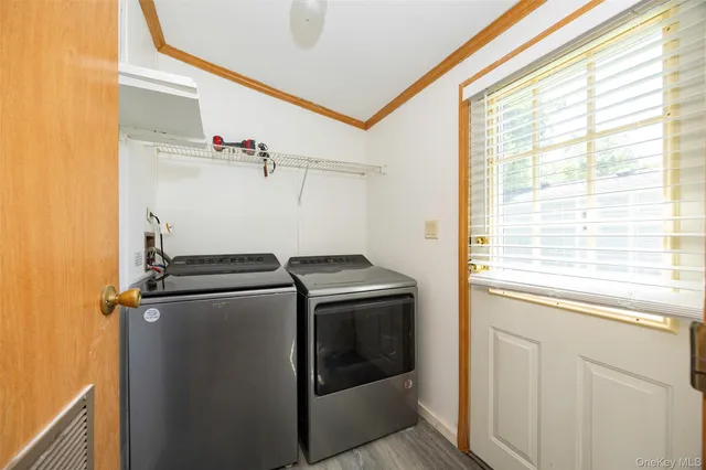 a view of a storage and utility room with washer and dryer