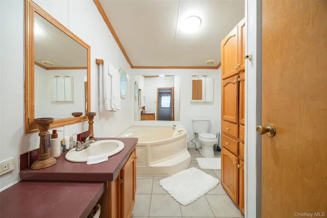 a bathroom with a sink a toilet and shower a mirror